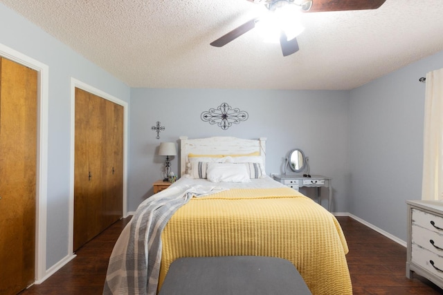 bedroom featuring ceiling fan, dark hardwood / wood-style floors, and a textured ceiling