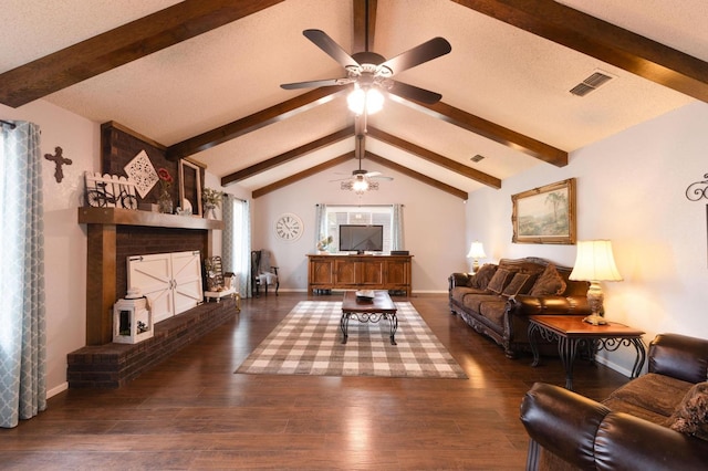 living room with lofted ceiling with beams, a textured ceiling, dark hardwood / wood-style floors, ceiling fan, and a fireplace