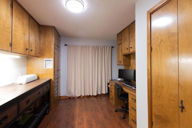 office with a textured ceiling and dark wood finished floors