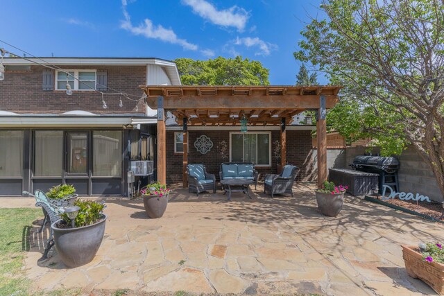 back of property with an outdoor hangout area, a patio area, a pergola, brick siding, and a sunroom
