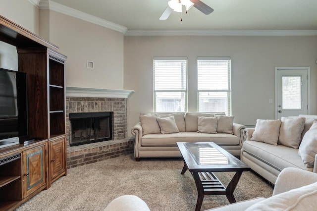 living room with ornamental molding, carpet, ceiling fan, and a brick fireplace