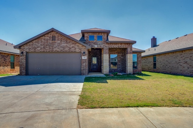 view of front of property featuring a garage and a front lawn