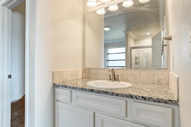 bathroom with ornamental molding and vanity