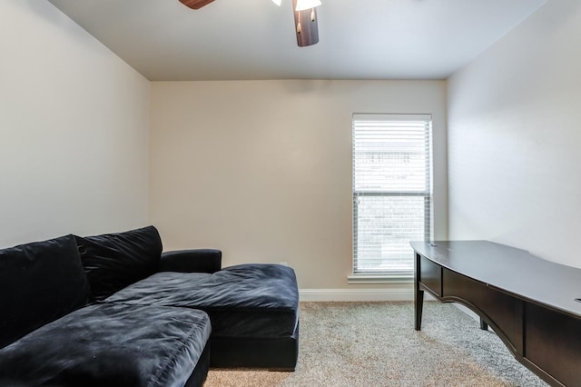 carpeted home office featuring ceiling fan