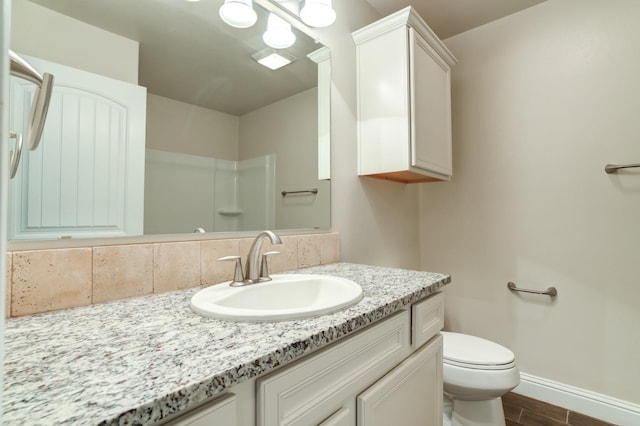 bathroom with vanity, hardwood / wood-style floors, and toilet