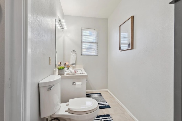 bathroom featuring vanity, tile patterned floors, and toilet