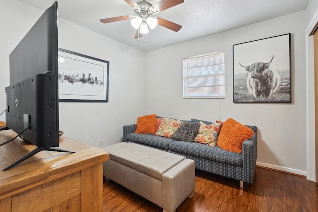 living room featuring dark wood-type flooring and ceiling fan