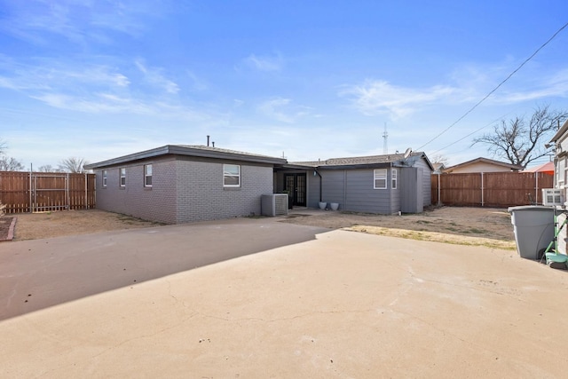 back of house featuring central AC unit and a patio