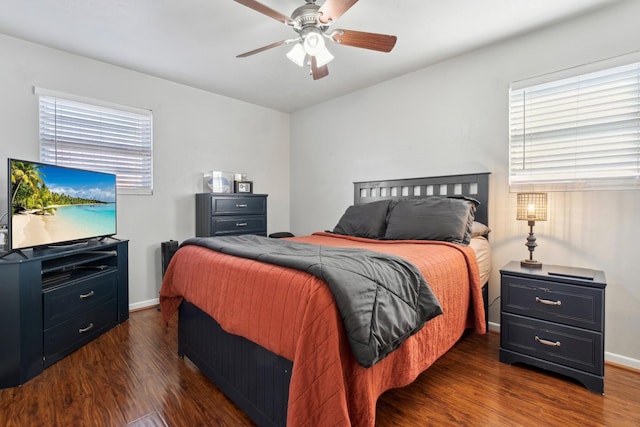 bedroom with ceiling fan, dark hardwood / wood-style floors, and multiple windows