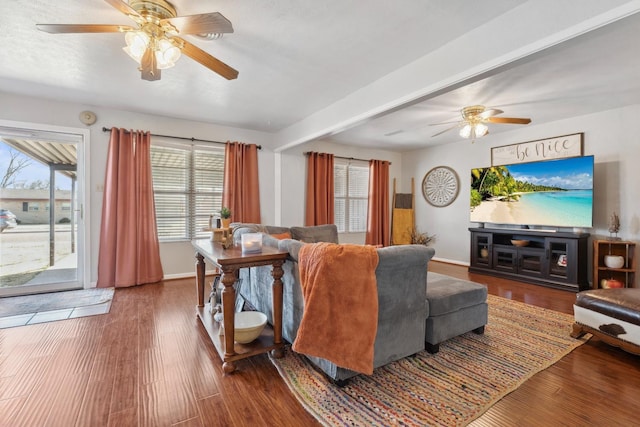 living room featuring ceiling fan, hardwood / wood-style flooring, a textured ceiling, and a healthy amount of sunlight