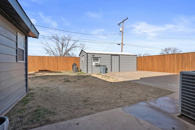 view of yard with a patio, central AC, and a storage shed