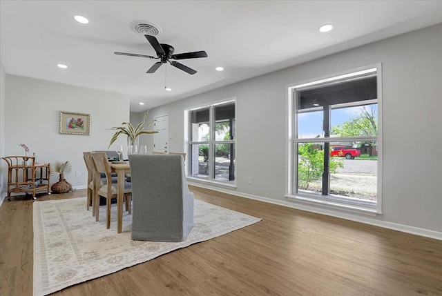 dining room with ceiling fan and hardwood / wood-style floors