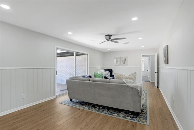 living room featuring ceiling fan and wood-type flooring