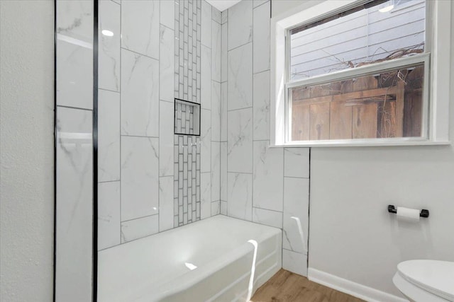 full bathroom with toilet, wood finished floors, and baseboards