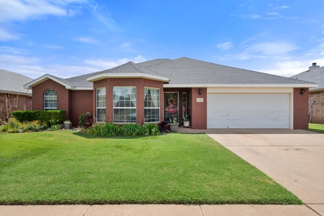 ranch-style home with a garage and a front yard