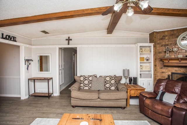 living room featuring vaulted ceiling with beams, crown molding, wood-type flooring, a textured ceiling, and ceiling fan