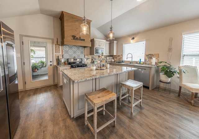 10323 Ave X, Lubbock, TX 79423 - kitchen featuring stainless steel appliances, vaulted ceiling, a kitchen island, tasteful backsplash, and dark wood finished floors