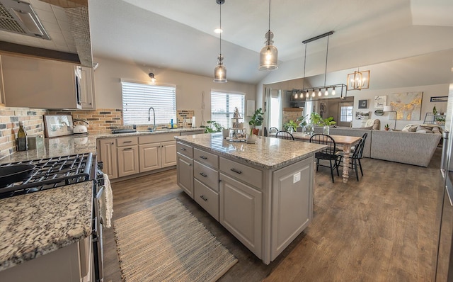 10323 Ave X, Lubbock, TX 79423 - kitchen with gas range, open floor plan, dark wood-style flooring, decorative backsplash, and light stone counters