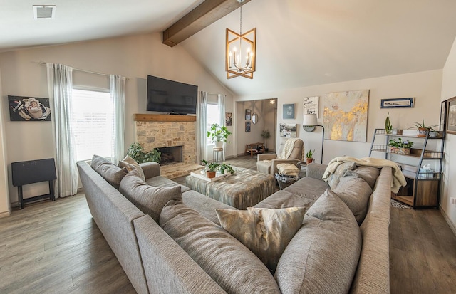 10323 Ave X, Lubbock, TX 79423 - living room featuring a chandelier, wood finished floors, and a fireplace with raised hearth