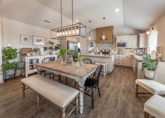 10323 Ave X, Lubbock, TX 79423 - dining space with lofted ceiling and dark wood finished floors