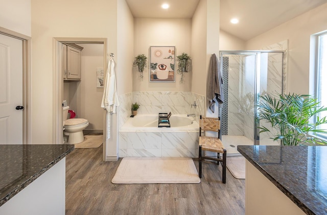 10323 Ave X, Lubbock, TX 79423 - full bath featuring a bath, wood finished floors, a shower stall, and recessed lighting