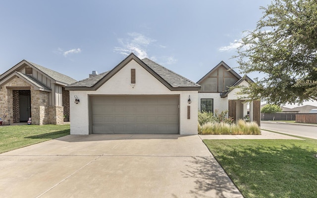 10323 Ave X, Lubbock, TX 79423 - view of front of house featuring brick siding, driveway, a front yard, an attached garage, and board and batten siding