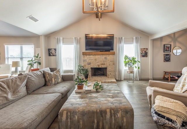 10323 Ave X, Lubbock, TX 79423 - living room featuring vaulted ceiling, wood finished floors, a chandelier, and a stone fireplace