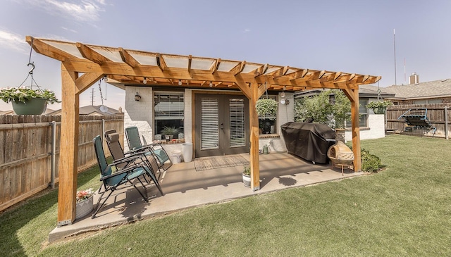 10323 Ave X, Lubbock, TX 79423 - fenced backyard with area for grilling, a pergola, french doors, and a patio