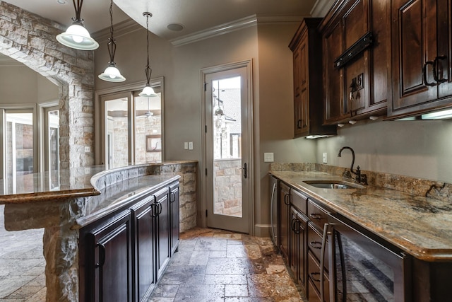kitchen featuring beverage cooler, stone tile floors, ornamental molding, and a sink