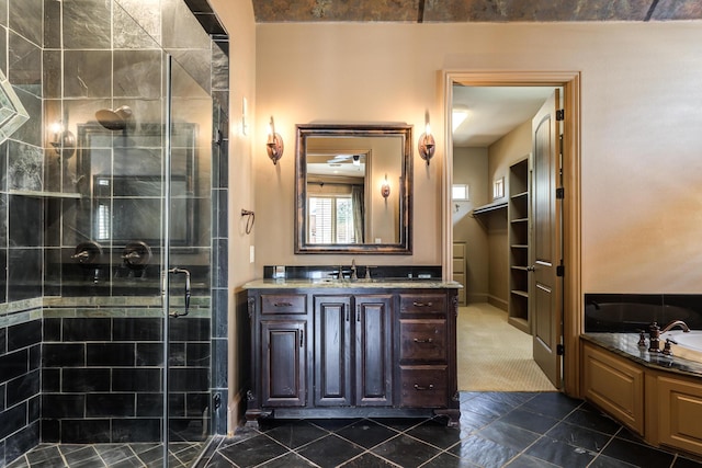 full bathroom featuring a garden tub, vanity, and a stall shower