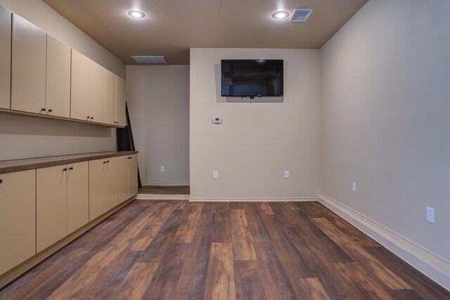 interior space with recessed lighting, dark wood finished floors, visible vents, and baseboards