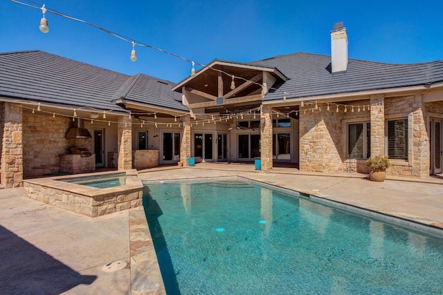 view of pool featuring a patio and a pool with connected hot tub