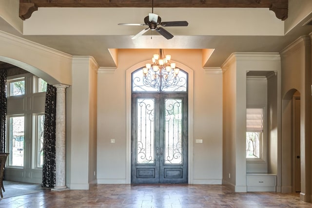 foyer entrance featuring arched walkways, ceiling fan with notable chandelier, baseboards, and french doors