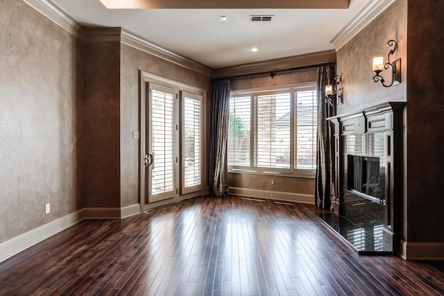 unfurnished living room with dark wood-style flooring, a healthy amount of sunlight, crown molding, and visible vents