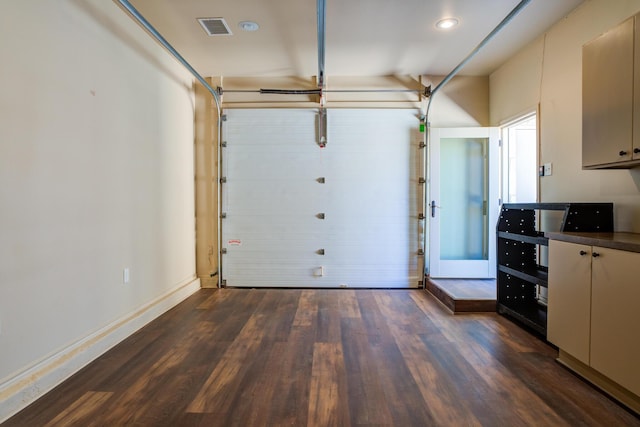 garage featuring baseboards and visible vents