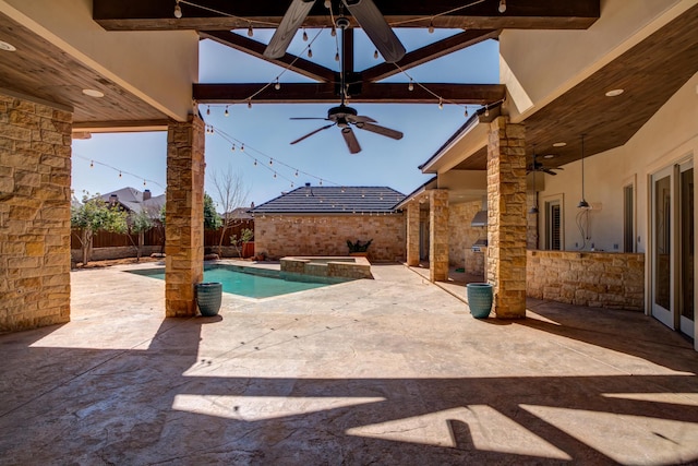 view of swimming pool with a ceiling fan, a pool with connected hot tub, a patio, and a fenced backyard