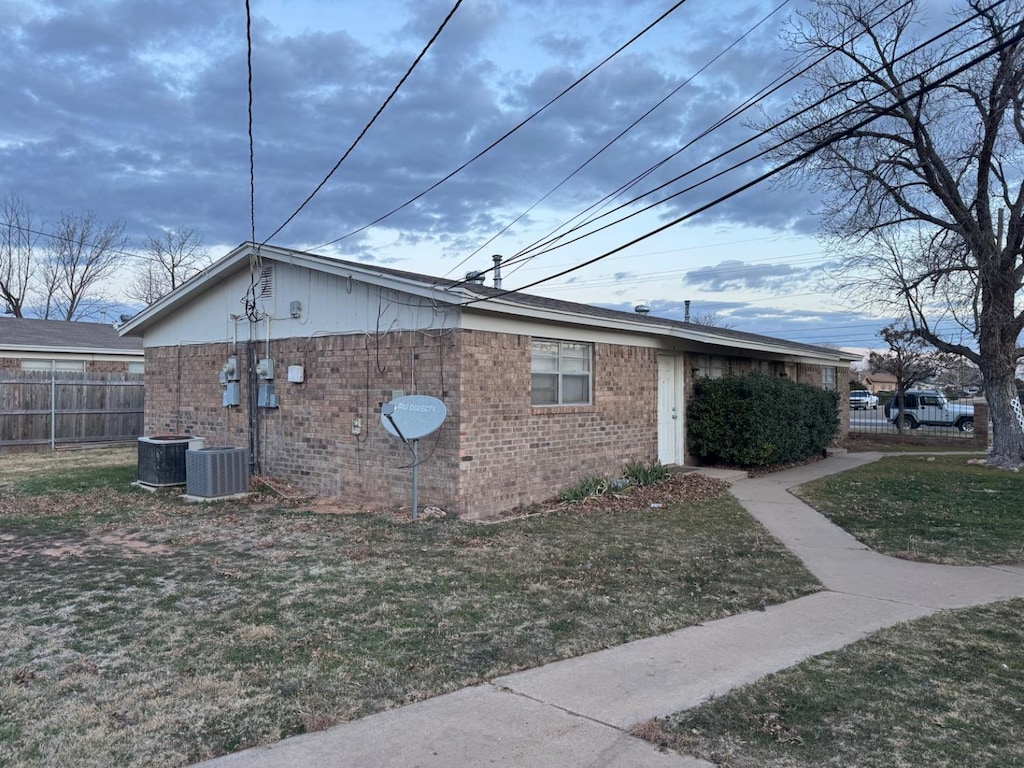 view of home's exterior featuring a lawn and central air condition unit