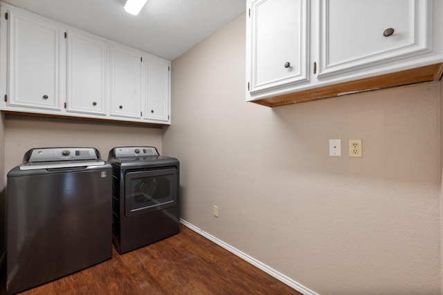 washroom with cabinets, dark wood-type flooring, and washer and clothes dryer