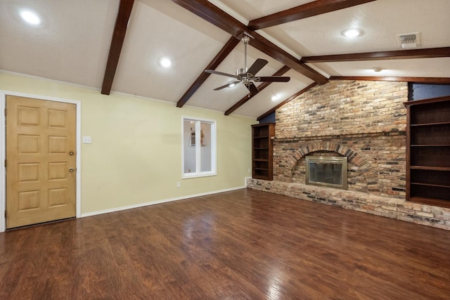 unfurnished living room featuring built in features, a fireplace, lofted ceiling with beams, ceiling fan, and dark wood-type flooring