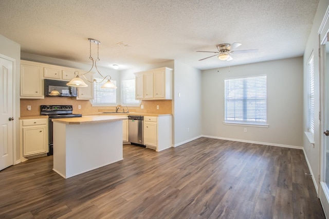 kitchen featuring white cabinetry, decorative light fixtures, and black appliances