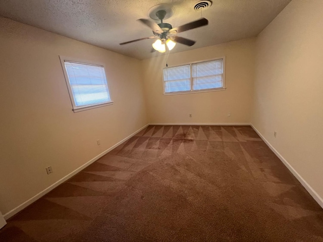 carpeted spare room with ceiling fan and a textured ceiling