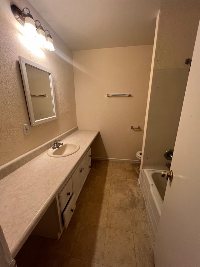 bathroom with vanity, toilet, tile patterned flooring, and a washtub