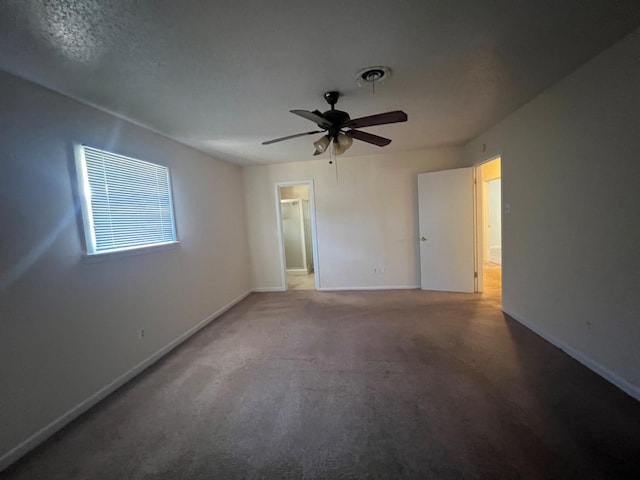 unfurnished room with ceiling fan and carpet