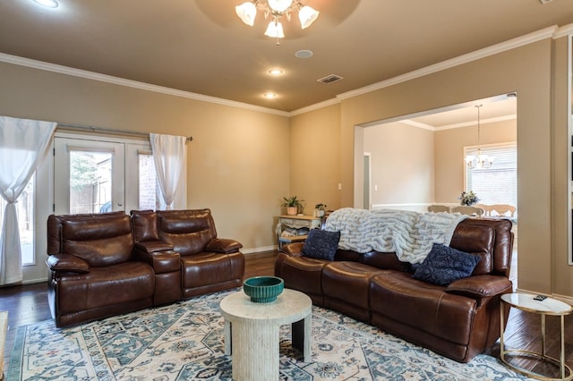 living room with hardwood / wood-style flooring, ornamental molding, and plenty of natural light