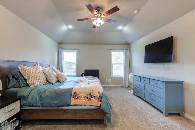 carpeted bedroom featuring ceiling fan, vaulted ceiling, and multiple windows