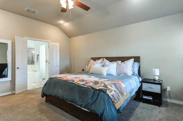 carpeted bedroom with ceiling fan, ensuite bath, and vaulted ceiling