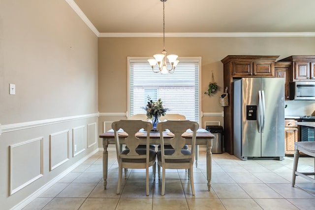 dining space with light tile patterned flooring, ornamental molding, and a notable chandelier