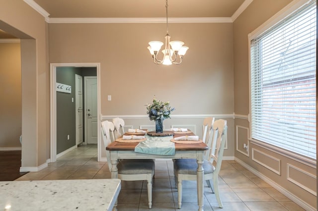 dining area featuring tile patterned flooring, crown molding, plenty of natural light, and a chandelier