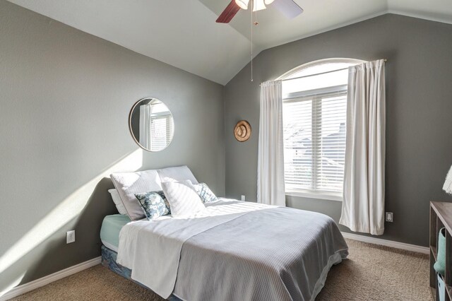 carpeted bedroom with vaulted ceiling and ceiling fan