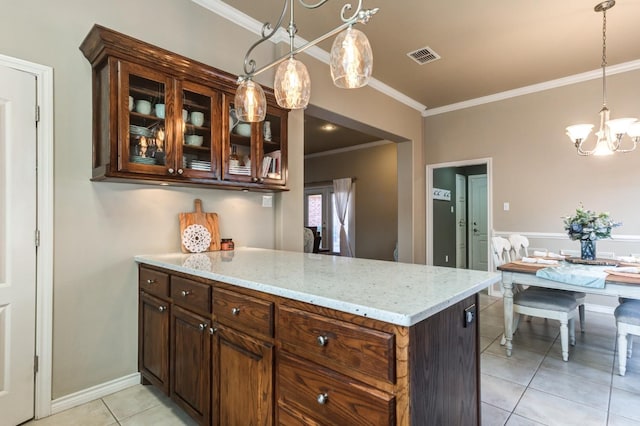 kitchen featuring hanging light fixtures, ornamental molding, light tile patterned floors, kitchen peninsula, and light stone countertops